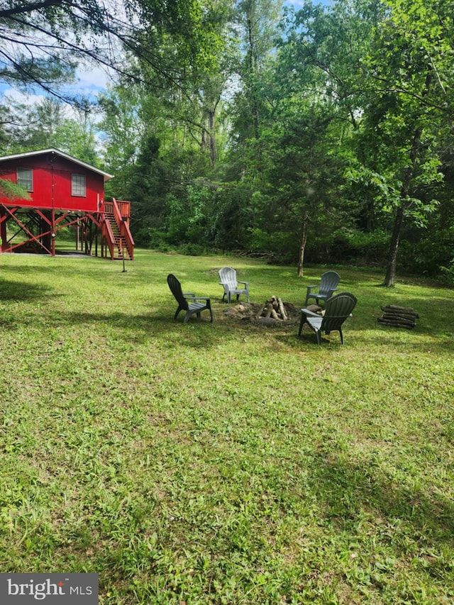 1615 Kilgore Rd, Paw Paw, WV 25434 - view of green lawn with stairs, an outdoor fire pit, and a deck