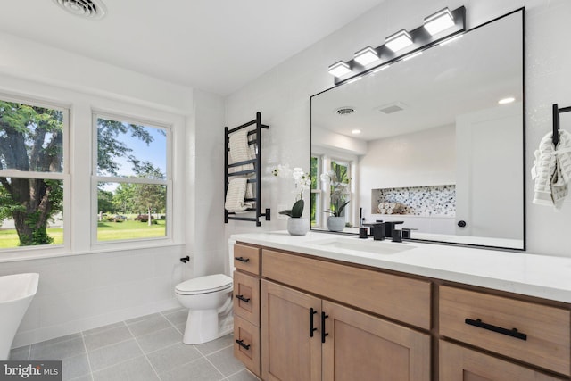 214 Dillard Ct, Front Royal, VA 22630 - full bath with healthy amount of natural light, tile patterned floors, vanity, toilet, and tile walls