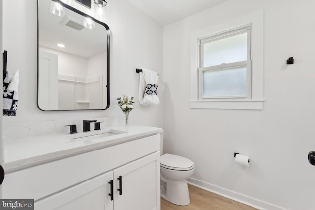 214 Dillard Ct, Front Royal, VA 22630 - bathroom featuring baseboards, toilet, wood finished floors, and vanity