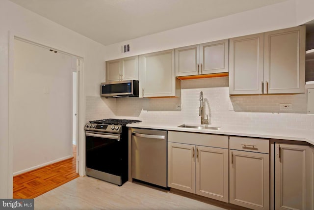 700 7th St SW Unit 507, Washington, DC 20024 - kitchen featuring stainless steel appliances, a sink, light countertops, and backsplash