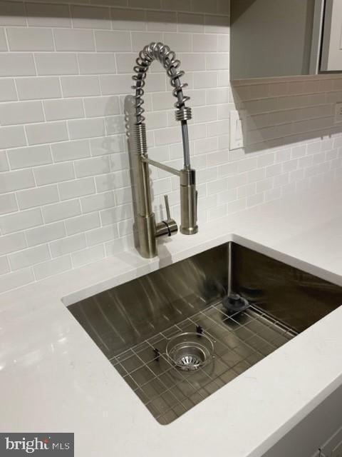 700 7th St SW Unit 507, Washington, DC 20024 - kitchen view of a sink, decorative backsplash, and light countertops
