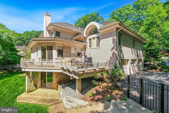 7005 Natelli Woods Ln, Bethesda, MD 20817 - back of property featuring brick siding, a garage, a chimney, concrete driveway, and a deck