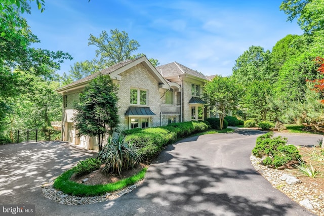 7005 Natelli Woods Ln, Bethesda, MD 20817 - traditional-style home with driveway, brick siding, and an attached garage