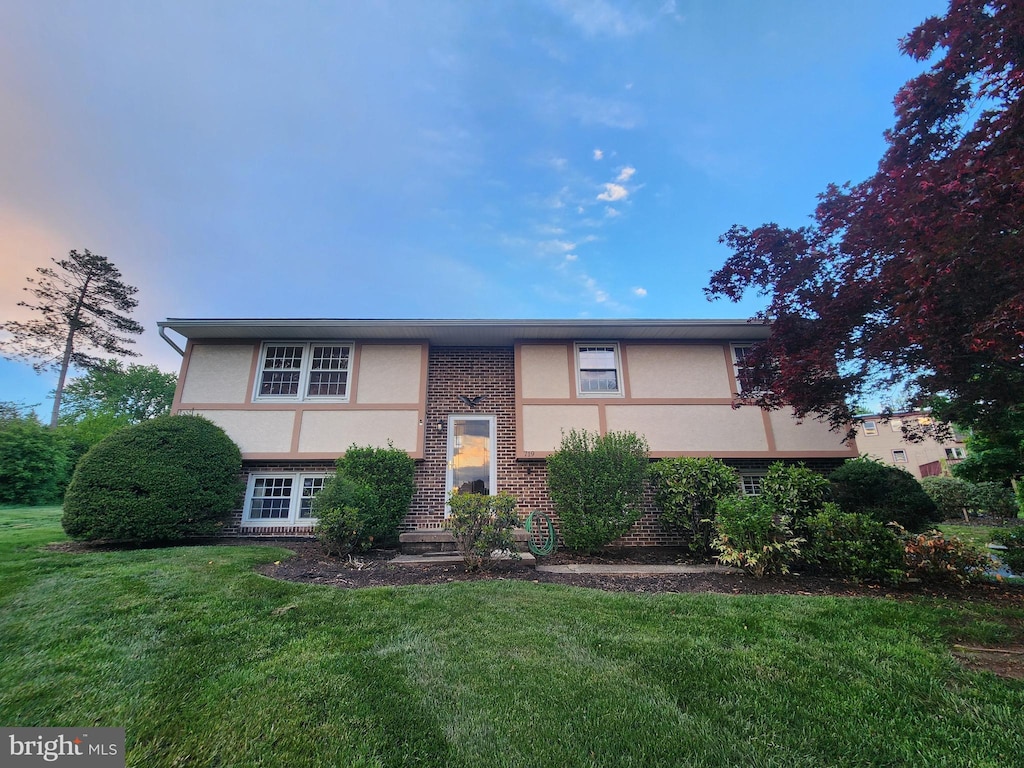 719 Loblolly Ln, Reading, PA 19607 - view of front facade with brick siding, stucco siding, and a front yard