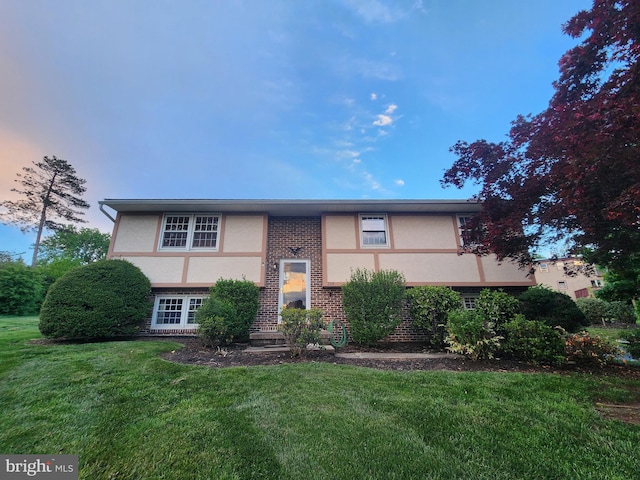 719 Loblolly Ln, Reading, PA 19607 - view of front facade with brick siding, stucco siding, and a front yard