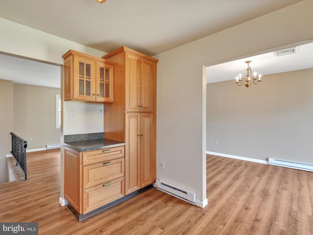 719 Loblolly Ln, Reading, PA 19607 - kitchen featuring a baseboard radiator, light wood-style flooring, and dark countertops