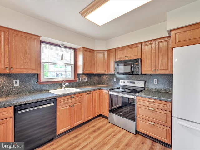 719 Loblolly Ln, Reading, PA 19607 - kitchen featuring black microwave, dishwashing machine, freestanding refrigerator, stainless steel electric range oven, and a sink