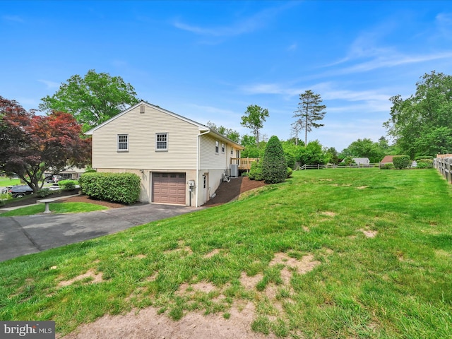 719 Loblolly Ln, Reading, PA 19607 - view of home's exterior with driveway, an attached garage, and a lawn