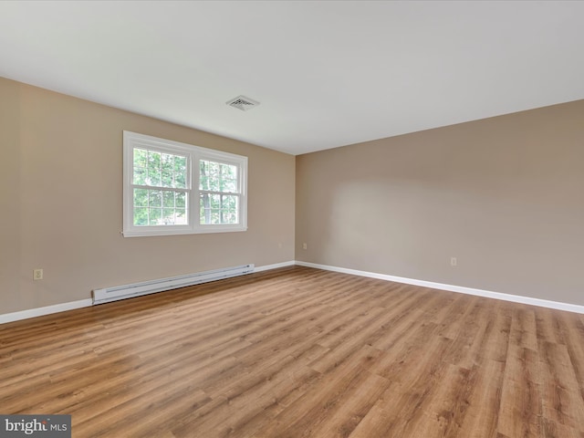 719 Loblolly Ln, Reading, PA 19607 - spare room with a baseboard heating unit, light wood-style flooring, and baseboards