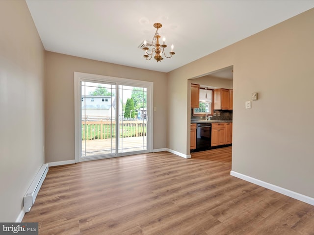 719 Loblolly Ln, Reading, PA 19607 - unfurnished living room with baseboard heating, a chandelier, baseboards, light wood-style flooring, and a sink