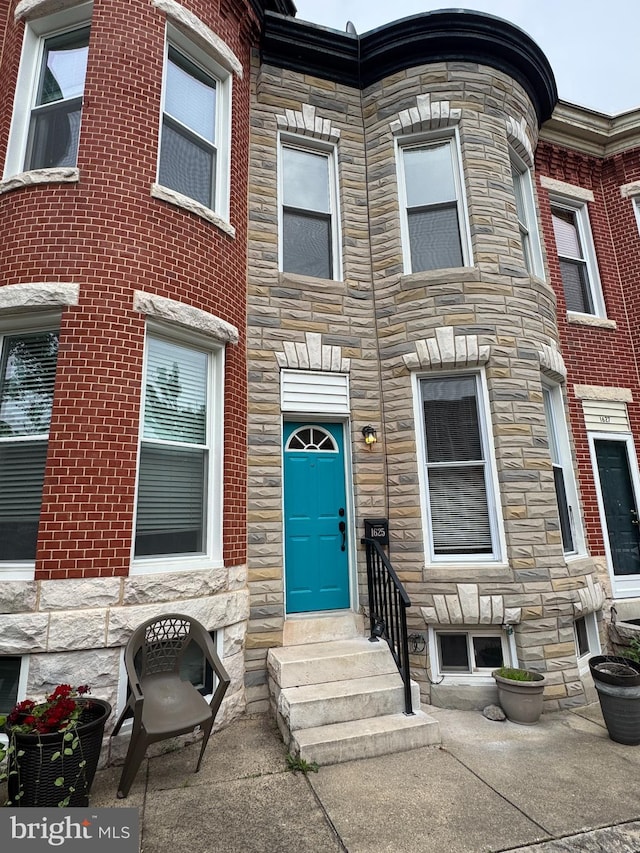 1625 Belt St, Baltimore, MD 21230 - townhome / multi-family property featuring stone siding and entry steps