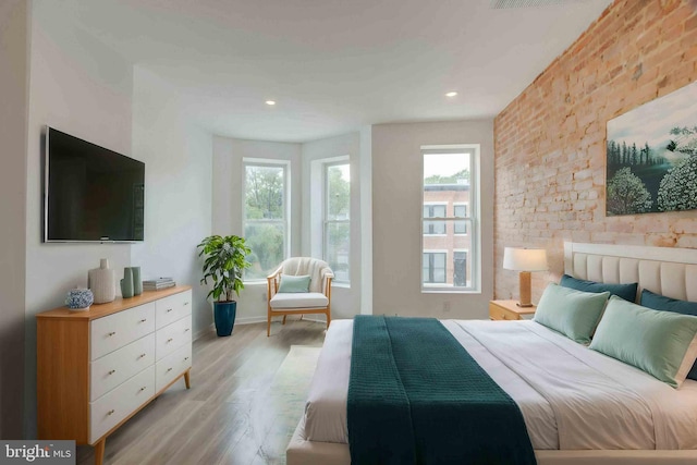 1625 Belt St, Baltimore, MD 21230 - bedroom with multiple windows, light wood-type flooring, brick wall, baseboards, and recessed lighting