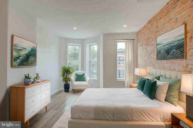 1625 Belt St, Baltimore, MD 21230 - bedroom featuring multiple windows, wood finished floors, recessed lighting, baseboards, and brick wall