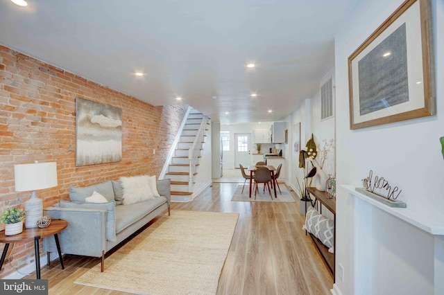 1625 Belt St, Baltimore, MD 21230 - living area featuring brick wall, stairs, light wood-style floors, recessed lighting, and baseboards