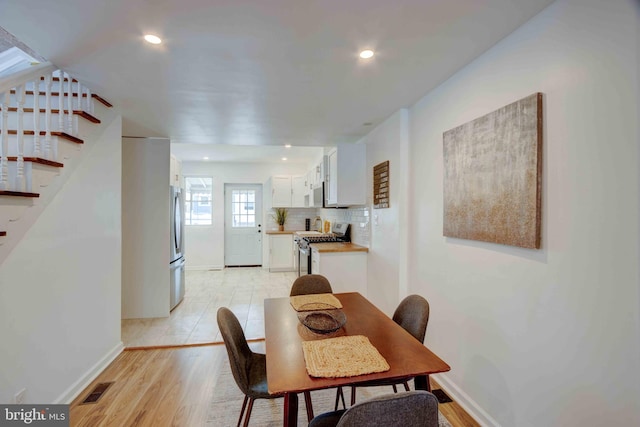 1625 Belt St, Baltimore, MD 21230 - dining space with baseboards, stairway, light wood-style floors, and recessed lighting