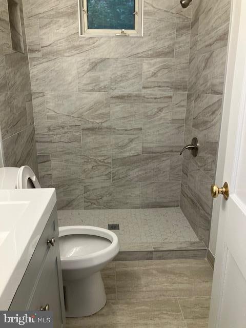 4027 Benton St NW Unit 101, Washington, DC 20007 - full bathroom featuring a stall shower, vanity, and toilet