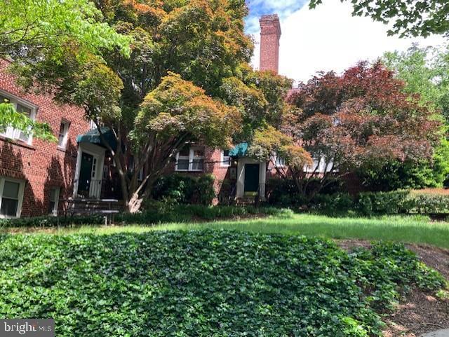 4027 Benton St NW Unit 101, Washington, DC 20007 - view of front facade with a chimney