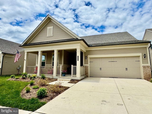 15741 Gardenia Ridge Way, Haymarket, VA 20169 - view of front facade featuring covered porch, driveway, a garage, roof with shingles, and brick siding