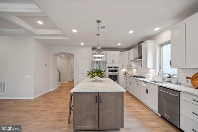 15741 Gardenia Ridge Way, Haymarket, VA 20169 - kitchen featuring stainless steel appliances, arched walkways, wall chimney range hood, a sink, and tasteful backsplash