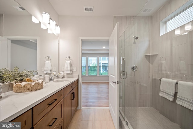 15741 Gardenia Ridge Way, Haymarket, VA 20169 - bathroom featuring healthy amount of natural light, vanity, a shower stall, and baseboards