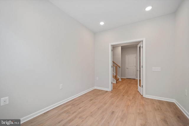 15741 Gardenia Ridge Way, Haymarket, VA 20169 - spare room with baseboards, light wood-style floors, stairway, and recessed lighting