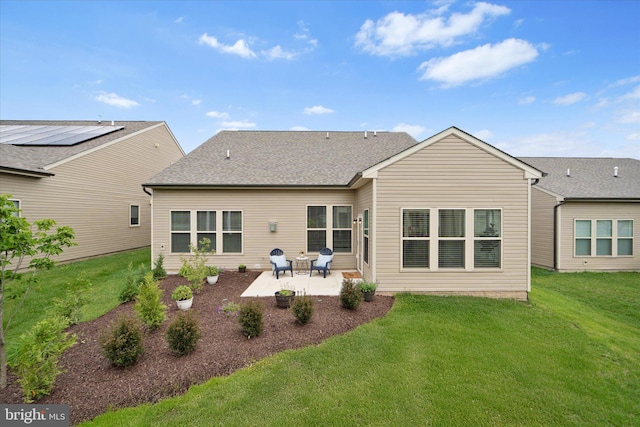 15741 Gardenia Ridge Way, Haymarket, VA 20169 - back of property featuring a patio area, a lawn, and a shingled roof