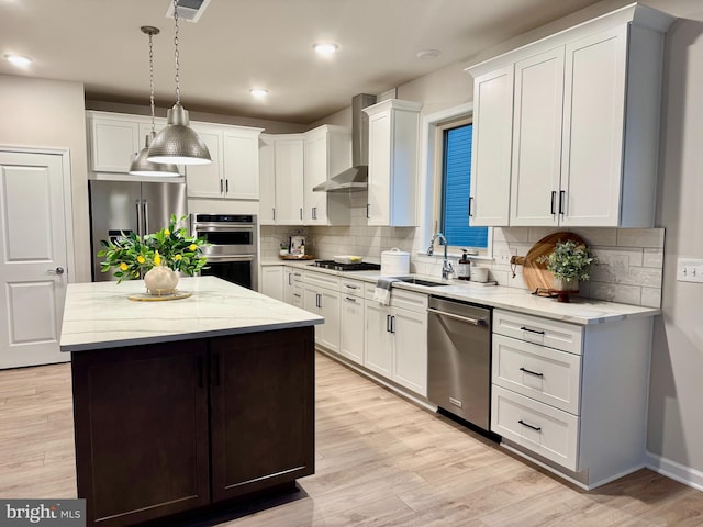 15741 Gardenia Ridge Way, Haymarket, VA 20169 - kitchen with stainless steel appliances, wall chimney exhaust hood, a sink, decorative backsplash, and recessed lighting