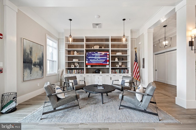 15741 Gardenia Ridge Way, Haymarket, VA 20169 - living room featuring wood finished floors, baseboards, built in features, and decorative columns