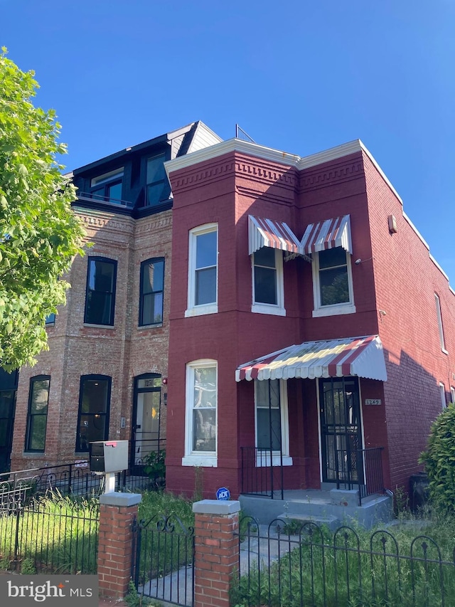 1249 Morse St NE, Washington, DC 20002 - townhome / multi-family property with a fenced front yard and brick siding
