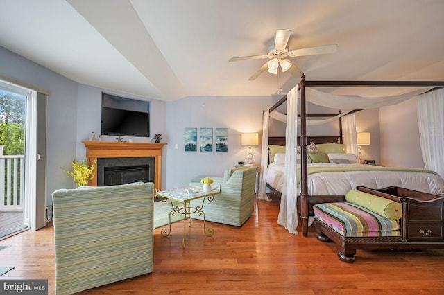 19830 Church St Unit 26, Rehoboth Beach, DE 19971 - bedroom with access to outside, a glass covered fireplace, wood finished floors, and a ceiling fan
