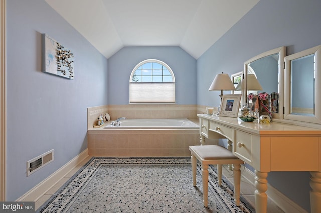 19830 Church St Unit 26, Rehoboth Beach, DE 19971 - bathroom featuring a garden tub, lofted ceiling, and baseboards