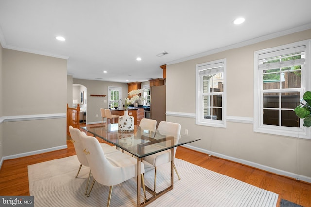 3949 Taney Ave, Alexandria, VA 22304 - dining room featuring arched walkways, recessed lighting, crown molding, baseboards, and light wood finished floors