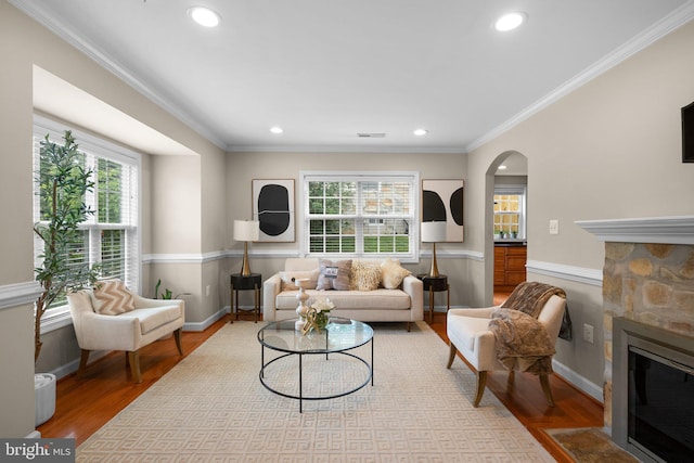 3949 Taney Ave, Alexandria, VA 22304 - living area with wood finished floors, a fireplace, ornamental molding, arched walkways, and recessed lighting