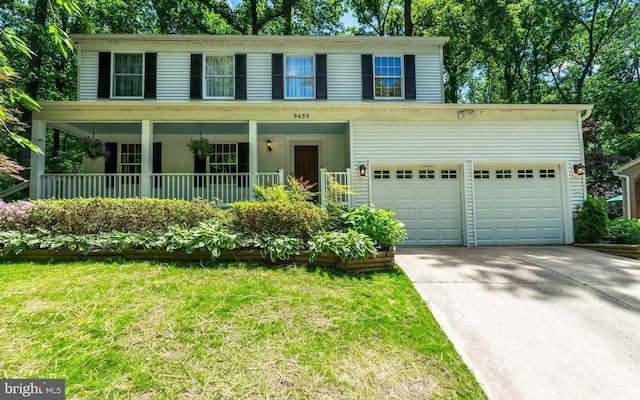 5455 Crowflock Ct, Columbia, MD 21045 - colonial home with concrete driveway, a front yard, and covered porch