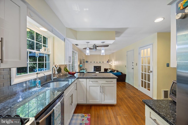 5455 Crowflock Ct, Columbia, MD 21045 - kitchen with a sink, white cabinetry, wood finished floors, decorative backsplash, and open floor plan