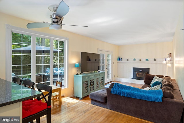 5455 Crowflock Ct, Columbia, MD 21045 - living area featuring a wood stove, wood finished floors, and ceiling fan
