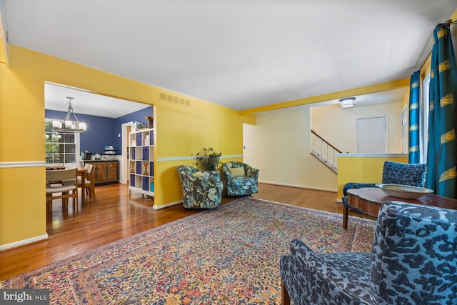 5455 Crowflock Ct, Columbia, MD 21045 - sitting room with wood finished floors, a chandelier, and stairway