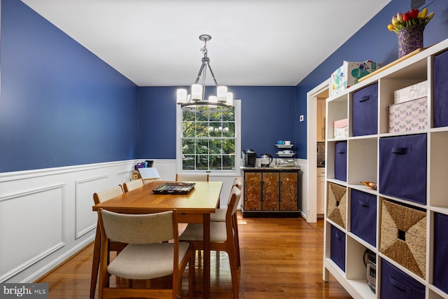 5455 Crowflock Ct, Columbia, MD 21045 - dining area featuring a chandelier, wood finished floors, and wainscoting