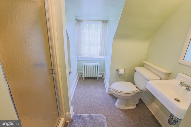 full bath with radiator, toilet, a shower stall, baseboards, and a sink