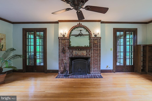unfurnished living room with french doors, wood finished floors, a ceiling fan, healthy amount of natural light, and ornamental molding