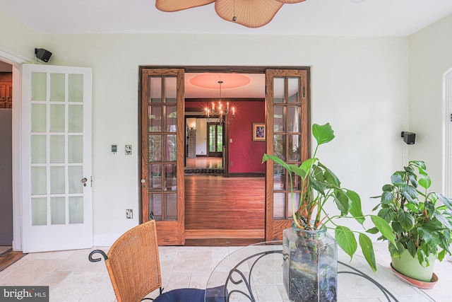 dining area with french doors, stone finish flooring, and ceiling fan