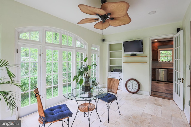 sunroom / solarium featuring french doors and stone tile floors