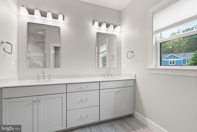 7101 27th Rd N, Arlington, VA 22213 - full bath with double vanity, baseboards, and wood finished floors