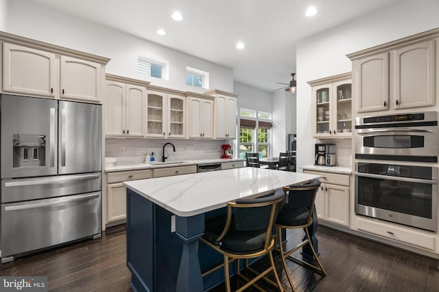 25146 Mineral Springs Cir, Aldie, VA 20105 - kitchen with appliances with stainless steel finishes, dark wood-style floors, tasteful backsplash, and recessed lighting