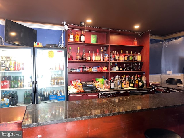 indoor dry bar featuring freestanding refrigerator and recessed lighting