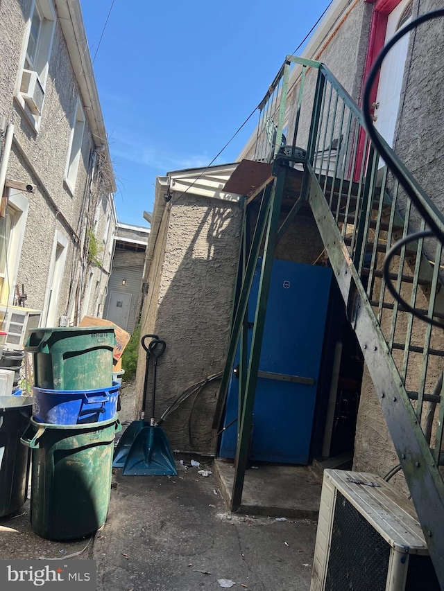 view of property exterior featuring stairs and cooling unit