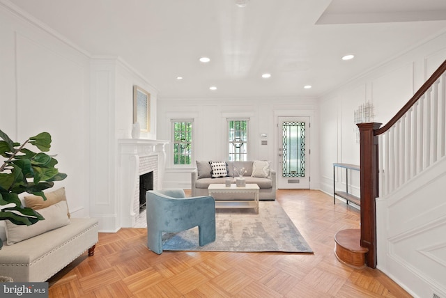 2314 20th St NW, Washington, DC 20009 - living room with ornamental molding, a decorative wall, stairs, recessed lighting, and a fireplace