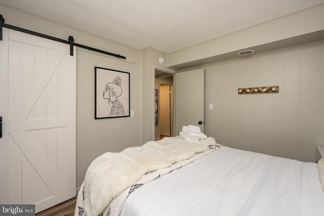 636 Paradise Hts, Oakland, MD 21550 - bedroom featuring a barn door and wood finished floors
