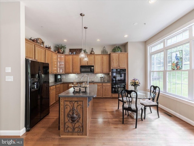 120 Whiteland Hills Cir, Exton, PA 19341 - kitchen featuring black appliances, dark countertops, healthy amount of natural light, a center island with sink, and recessed lighting