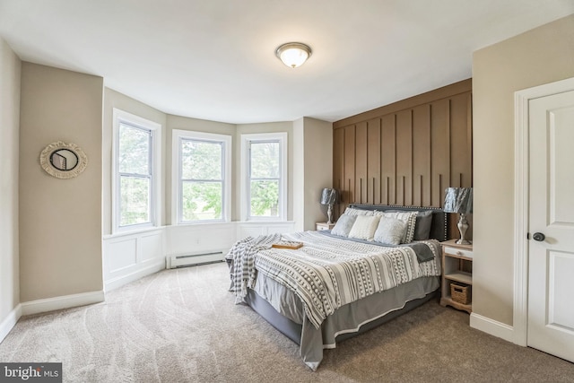 bedroom with carpet floors, a baseboard radiator, and baseboards